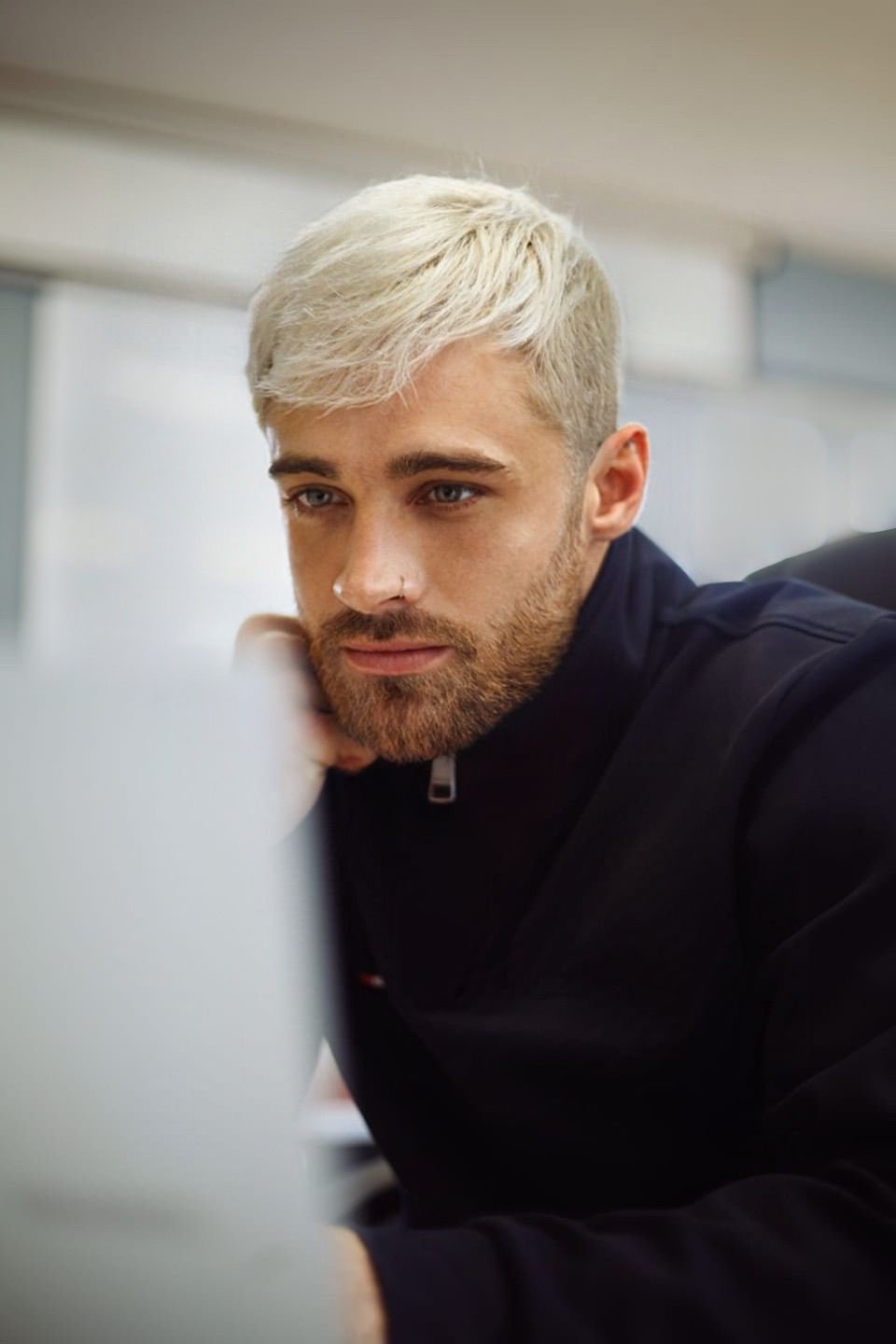 Zack - Portrait photo with platinum blonde hair, dark clothing, professional headshot style
